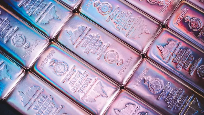 The popular silver thesis says a record sixth-straight supply deficit makes higher prices a near-certainty. That is the wrong way to read this market. Silver is not a one-way deficit trade — it is the highest-beta macro instrument in the precious-metals complex, and the same structural shortfall that powers the bull case is exactly what makes the bear case so violent. After silver ran to an all-time high earlier in 2026 and then shed roughly 44% in a brutal correction, the metal trades near $70 per ounce (LBMA, June 15, 2026), with the 2026 analyst range running from a $44 deep-bear print to a $150 bull call. The gold-to-silver ratio sits around 62:1, modestly below its 50-year average, which tells you silver is cheap relative to gold — but "cheap" and "going up in a straight line" are not the same trade.
Here is the angle most coverage misses: silver's deficit is real and growing, yet silver still fell 44% from its peak. That single fact dismantles the "deficit equals moonshot" narrative. Unlike gold, silver has no structural central-bank bid to cushion drawdowns — when macro turns risk-off and real yields rise, silver gets sold first and hardest, deficit or not. The metal is best understood as a leveraged bet on gold's direction plus the industrial cycle, not as a steady store of value. That framing — silver as a volatility engine rather than a compounding hedge — is the lens this forecast uses to lay out the bull and bear numbers.
<strong>Key Facts:</strong>
Silver spot: roughly $70/oz, down about 44% from its 2026 record high — <a href="https://goldsilver.com/industry-news/article/silver-price-outlook-june-2026/">GoldSilver, June 15, 2026</a>
2026 market deficit: 46.3 million ounces, the sixth consecutive annual shortfall — <a href="https://silverinstitute.org/global-silver-investment-to-remain-strong-in-2026-against-the-backdrop-of-a-sixth-consecutive-annual-market-deficit/">World Silver Survey 2026, Silver Institute & Metals Focus</a>
Cumulative drawdown: about 762 million ounces pulled from above-ground stockpiles since 2020 — Metals Focus
Bull case: $90–$106 year-end, with Citi standing by a $150 call for 2026 — <a href="https://www.financemagnates.com/trending/how-high-can-silver-go-silver-price-predictions-target-300-in-2026/">Finance Magnates</a>
Bear case: a retest of $60–$63 support, with TD Securities at $44 as the deep-bear outlier
Consensus: LBMA 2026 survey averages about $79.50; J.P. Morgan $81; UBS $80 year-end — <a href="https://www.jpmorgan.com/insights/global-research/commodities/silver-prices">J.P. Morgan Global Research</a>
Physical investment: forecast up 20% to a three-year high of 227 million ounces — Metals Focus
What's actually happening — and why silver fell 44%
Silver wears two hats: half industrial metal, half monetary asset. Roughly 50% of annual demand comes from industry — solar panels, electric vehicles, electronics, and increasingly AI data-centre hardware — while the rest is investment and jewellery. That dual identity is why silver out-runs gold in bull phases and crashes harder in busts: it carries gold's monetary beta and the industrial cycle's cyclicality at the same time. The industrial leg is shifting in composition rather than shrinking: solar photovoltaic manufacturers have cut silver loadings per cell through thrifting and substitution, yet demand from electric vehicles, grid electronics and AI data-centre hardware is rising fast enough to keep total industrial offtake near multi-hundred-million-ounce levels. That rotation matters because it diversifies silver's demand base away from a single end-market — a structurally healthier mix than the solar-dependent story of three years ago, even if the headline industrial figure dips.
The 2026 story is a textbook squeeze-then-flush. By September 2025, freely available silver in London vaults had fallen to a historic low of about 17% unencumbered, which triggered an October 2025 physical-liquidity squeeze that sent lease rates spiking and drove the metal to its record high. Then the macro turned. With the Federal Reserve under new leadership holding rates and signalling no cuts, real yields firmed and the dollar held bid — a textbook headwind for non-yielding metals. Leveraged longs that had piled in during the squeeze were flushed, and silver gave back 44% in months.
The deficit, meanwhile, kept widening. The <a href="https://financefeeds.com/silver-price-forecast-2026-year-end/">2026 year-end silver forecast</a> rests on a shortfall that persists because mine supply is contracting faster than industrial demand is softening. Even with solar manufacturers "thrifting" — using less silver per panel — the structural gap remains. As Philip Newman of Metals Focus framed the investment side of the equation:
<blockquote>Exchange-traded fund inflows have increased by 187 million ounces, reflecting "investor concerns over stagflation, the Federal Reserve's independence, government debt sustainability, the US dollar's role as a safe haven, and geopolitical risks."
— <strong>Philip Newman</strong>, Managing Director at Metals Focus (<a href="https://silverinstitute.org/global-silver-investment-to-remain-strong-in-2026-against-the-backdrop-of-a-sixth-consecutive-annual-market-deficit/">World Silver Survey 2026</a>)</blockquote>
How miners, ETF issuers and banks are positioning
The market's professional participants are not reading the deficit as a green light for unhedged length. Miners, refiners, ETF issuers and bank desks have each repositioned around volatility rather than a one-way move.
On the investment-product side, physical silver ETFs are seeing renewed Western inflows after the correction, with physical investment forecast to climb 20% to a three-year high of 227 million ounces (Metals Focus). The large physically backed vehicles — iShares Silver Trust and Sprott Physical Silver Trust among them — are the visible expression of that bid, and their holdings are the cleanest real-time gauge of investor conviction. When those holdings rise into a falling price, it signals accumulation; when they bleed alongside price, it confirms a momentum unwind.
The sell-side is openly split, which is itself the story. Citi is standing by a $150 call for 2026 while also lifting its near-term target, citing industrial demand and geopolitical volatility. UBS went the other way, trimming its year-end forecast to $80 from $85 on weaker photovoltaic and jewellery demand at elevated prices. J.P. Morgan sits in the middle at an $81 average and has flagged that, without central banks as structural dip-buyers, the gold-to-silver ratio carries upside risk — analyst-speak for silver underperforming gold. That tension between a structural-deficit bull case and a macro-driven bear case is the same dynamic FinanceFeeds tracked when <a href="https://financefeeds.com/gold-and-silver-erase-year-to-date-gains-as-rate-fears-hit-precious-metals/">gold and silver erased year-to-date gains on rate fears</a>.
Market impact and data synthesis: why the deficit cuts both ways
Stack three numbers together and the real picture emerges. The 2026 deficit is 46.3 million ounces; the cumulative 2020–2025 drawdown is about 762 million ounces; and London's free float fell to roughly 17% in late 2025. Combined, they explain why silver is structurally tight yet prone to violent swings: there is less and less buffer inventory to absorb a demand shock, so any surge in physical or ETF demand can spike the price — and any rush for the exits can collapse it just as fast. Thin float plus high beta equals a market that gaps in both directions.
That is the synthesis competitors miss when they cite the deficit as a one-directional catalyst. A shrinking above-ground buffer raises the ceiling and lowers the floor simultaneously. It is why a metal in its sixth deficit year could still fall 44%, and why the same metal could spike toward triple digits on a single delivery-stress episode.
The lease-rate signal is the tell most retail coverage ignores. When freely available metal is scarce, the cost to borrow silver rises, and spiking lease rates are an early-warning system for a squeeze — they led the October 2025 move before spot reacted. With physical investment forecast to rise 20% to 227 million ounces and ETF inflows already up 187 million ounces, the demand side is rebuilding even as the float stays thin. That combination — recovering investment demand into a depleted buffer — is precisely the setup that produces the asymmetric upside spikes, and it is why disciplined desks watch vault free-float and lease rates rather than the deficit headline alone.
Scenario2026 targetKey driversWhat confirms it
<strong>Bull case</strong>$90–$106 (stretch: $150, Citi)Deepening deficit, ETF inflows, a COMEX/LBMA delivery squeeze, Fed signalling no hikesETF holdings rising into strength; lease rates spiking again
<strong>Base case</strong>$79–$85LBMA survey ~$79.50; JPM $81; ING $83; UBS $80Range-bound trade around the consensus band
<strong>Bear case</strong>$60–$63 (deep: $44, TD Securities)Resilient dollar, sticky inflation, hawkish Fed, softer industrial demandWeekly close below $60 support; ETF outflows
<em>Sources: GoldSilver June 2026 outlook; J.P. Morgan Global Research; LBMA 2026 forecast survey; Citi and UBS published targets; TD Securities. Compiled June 21, 2026.</em>
For comparison, the same bull/bear framing applied to the yellow metal — laid out in our <a href="https://financefeeds.com/gold-price-prediction-bull-bear-cases-2026/">gold price prediction bull and bear cases</a> — shows gold with a far narrower distribution. Silver's range is roughly three times as wide in percentage terms, which quantifies its higher beta in a single comparison.
The macro and market-structure tension
Silver has no dedicated regulator setting its price, but it sits at the intersection of two powerful forces: monetary policy and physical market structure. On policy, the Federal Reserve's hawkish hold is the single biggest swing factor. Higher-for-longer real yields raise the opportunity cost of holding a non-yielding metal, and a firm dollar caps dollar-denominated commodity prices — the macro backdrop behind the spring correction, and the reason <a href="https://financefeeds.com/goldman-sachs-slashes-gold-forecast/">Goldman Sachs trimmed its gold forecast as Fed fears mounted</a>.
On market structure, the tension is between paper and physical. The COMEX futures market and the LBMA's London vaults can diverge sharply when free float is scarce, as the October 2025 squeeze demonstrated. With unencumbered London inventory historically low, the risk of another delivery-stress episode — where futures shorts scramble for deliverable metal — is elevated. That is the mechanism most likely to deliver the bull-case spike, and it is a market-structure risk, not a forecast. Regulators including the US Commodity Futures Trading Commission monitor positioning and delivery, but they do not backstop price; in a genuine squeeze, the metal reprices first and questions are asked later.
What happens next: the predictions
Three calls, with reasoning. First, the base case: silver finishes 2026 in the $79–$85 band, consistent with the LBMA survey and the J.P. Morgan and UBS targets, as the structural deficit provides a floor while the hawkish-Fed macro caps the upside. Second, the asymmetric risk skews toward at least one sharp spike: given the thin London float, a COMEX delivery-stress event before year-end could push silver into the $100–$110 zone briefly, making Citi's high call reachable on a squeeze even if it does not hold. Third, the bear scenario is live and should not be dismissed: a renewed dollar surge or a hawkish Fed surprise could retest $60–$63, with the $44 TD Securities print only plausible on a broad commodity-and-risk washout.
The throughline is that silver in 2026 is a trade about volatility and timing, not a buy-and-forget hedge. The deficit underwrites the long-term floor; the macro and the thin float dictate the path. Ole Hansen of Saxo Bank captured the relative-value caution that belongs in any silver forecast:
<blockquote>"If gold moves toward US$6,000, I would believe that ... silver at some point will struggle to keep up, and we'll see basically gold relatively outperform silver."
— <strong>Ole Hansen</strong>, Head of Commodity Strategy at Saxo Bank (<a href="https://investingnews.com/ole-hansen-resource-market-forecast/">Investing News Network</a>)</blockquote>
Having watched silver round-trip from a record high to a 44% drawdown in a single year, the lesson for institutional allocators is positioning discipline: size silver as the high-beta sleeve of a metals allocation, not the core. The deficit is the reason to own it; the volatility is the reason to size it carefully.
FAQ
<strong>What is the silver price prediction for 2026?</strong>
The base case puts silver at $79–$85 by year-end 2026, in line with the LBMA survey average of about $79.50 and J.P. Morgan's $81 call. The bull case runs to $90–$106, with Citi standing by $150, while the bear case targets $60–$63 and a deep-bear outlier of $44 from TD Securities.
<strong>Why did silver fall 44% in 2026?</strong>
Silver spiked to a record high during the October 2025 London liquidity squeeze, then corrected as the Federal Reserve held rates and signalled no cuts. Firmer real yields and a resilient dollar flushed leveraged long positions, even as the structural supply deficit kept widening.
<strong>Is silver undervalued versus gold?</strong>
On the gold-to-silver ratio of about 62:1 — modestly below the 50-year average of 65–70:1 — silver looks mildly cheap relative to gold. But without central-bank dip-buying, J.P. Morgan warns the ratio could move higher, meaning silver may underperform gold even if both rise.
<strong>What could push silver to $100 or more?</strong>
A COMEX or LBMA delivery-stress episode is the most likely trigger. With unencumbered London inventory near historic lows, a scramble for deliverable metal could spike prices into the $100–$110 zone, making Citi's high target reachable on a squeeze.
<strong>What is the bear case for silver?</strong>
A renewed dollar rally, sticky inflation, a hawkish Fed surprise, or softening industrial demand could send silver back to the $60–$63 support area, roughly 15% below current levels, with $44 possible only in a broad risk-off washout.
<strong>How does the supply deficit affect the price?</strong>
The 2026 deficit of 46.3 million ounces adds to a cumulative drawdown of about 762 million ounces since 2020, steadily depleting the above-ground buffer. A thinner buffer makes the market more sensitive to demand shocks in both directions, raising the odds of sharp spikes and sharp corrections rather than a smooth trend.
<strong>Should silver be a core or satellite holding?</strong>
On its 2026 risk profile, silver fits best as a high-beta satellite position within a precious-metals allocation rather than the core. Gold offers the steadier monetary hedge with central-bank support; silver offers leveraged upside and matching downside, so position sizing is the key risk control.
<em>This article is informational analysis only and is not investment, financial, or trading advice. Commodities are volatile and prices can move sharply in either direction. Always do your own research and consult a regulated adviser before making investment decisions.</em>